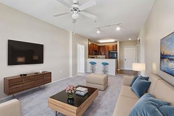 Northridge apartment for rent - A living room with a brown coffee table and a flat screen TV mounted on the wall.