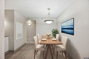 Reno apartment for rent - A dining room with a wooden table and chairs.