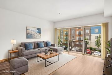 Lynnwood apartment for rent - A living room with a grey couch and a painting on the wall.