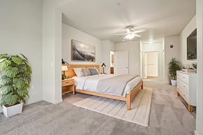 Redmond apartment for rent - A bedroom with a bed, dresser, and ceiling fan.