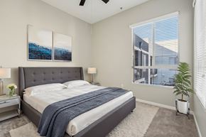 Woodland Hills apartment for rent - A bedroom with a large bed and a ceiling fan.
