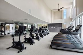 San Diego apartment for rent - A gym with a row of treadmilers and elliptical machines.