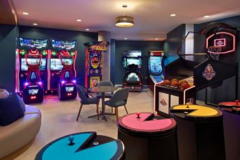 Sports lounge & game room with arcade games & bowling lanes