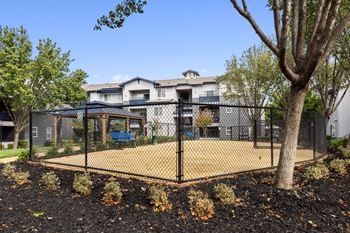 Fenced dog park with pet watering station