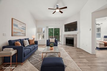 Hillsboro apartment for rent - A living room with a blue couch and a painting on the wall.