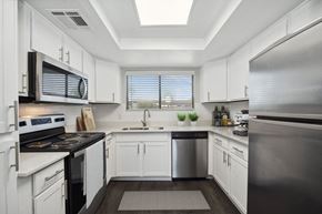 Phoenix apartment for rent - a kitchen with white cabinets and stainless steel appliances