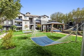 Tracy apartment for rent - a yard with hammocks and a gazebo in front of an apartment