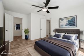 Hillsboro apartment for rent - A bedroom with a bed, a ceiling fan, and a painting on the wall.