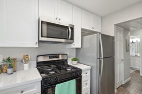 Upland apartment for rent - a kitchen with stainless steel appliances and white cabinets
