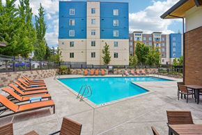 Lynnwood apartment for rent - A pool surrounded by sun loungers and chairs.