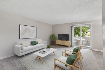 Sparks apartment for rent - the living room of an apartment with a white couch and chairs