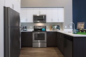 Fremont apartment for rent - a kitchen with white cabinets and stainless steel appliances