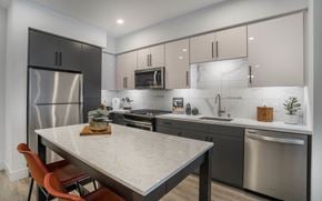 Anaheim apartment for rent - a kitchen with stainless steel appliances and a marble counter top