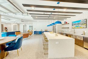 Phoenix apartment for rent - A kitchen with a long table and blue chairs.