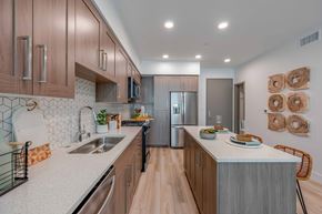 Anaheim apartment for rent - A kitchen with wooden cabinets and a white countertop.