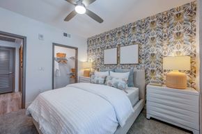 Anaheim apartment for rent - A bedroom with a large bed and a ceiling fan.