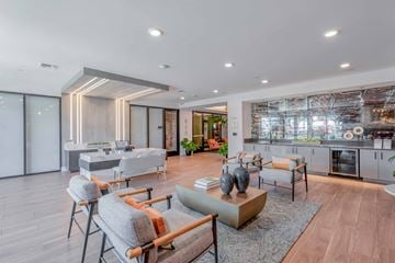 Anaheim apartment for rent - A modern living room with a grey sofa and a wooden coffee table.