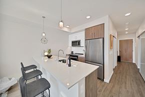 Kirkland apartment for rent - a kitchen with a large island and a stainless steel refrigerator