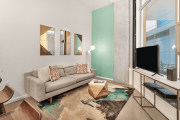 Seattle apartment for rent - A living room with a grey couch and a rug.