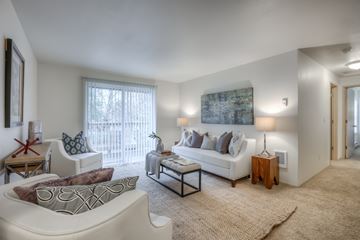 Gresham apartment for rent - A living room with a white couch, a coffee table, and a painting on the wall.
