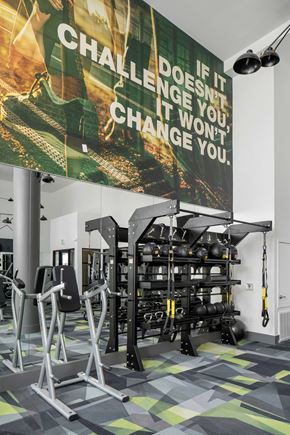 Tempe apartment for rent - a gym with weights and a poster on the wall
