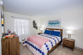 Las Vegas apartment for rent - A bedroom with a bed, nightstand, and a painting on the wall.