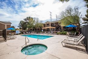 Las Vegas apartment for rent - A swimming pool with a slide and lounge chairs.