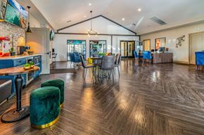 Henderson apartment for rent - a clubhouse with a dining area and a kitchen with a table and chairs