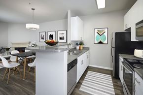 Denver apartment for rent - an open kitchen with a large island and a dining table