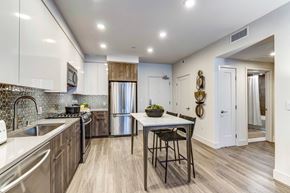 Mountain View apartment for rent - a kitchen with stainless steel appliances and a table with two stools