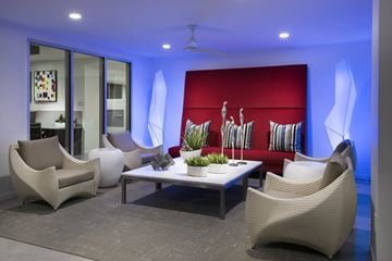 Phoenix apartment for rent - a living room with white chairs and a red couch