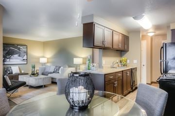 Gresham apartment for rent - A modern living room with a glass table and a large vase.