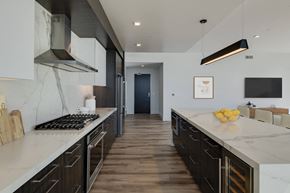 San Diego apartment for rent - a large kitchen with marble counter tops and wooden floors