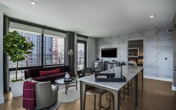 San Diego apartment for rent - A modern living room with a red sofa and a glass table.