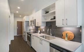 Seattle apartment for rent - a kitchen with white cabinets and stainless steel appliances