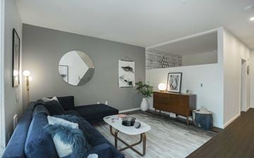 Seattle apartment for rent - a living room with a blue couch and a white coffee table