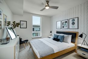 Seattle apartment for rent - a bedroom with a large bed and a ceiling fan