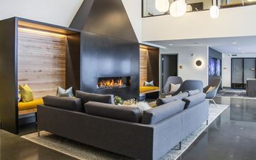 Seattle apartment for rent - A modern living room with a grey sofa and a fireplace.