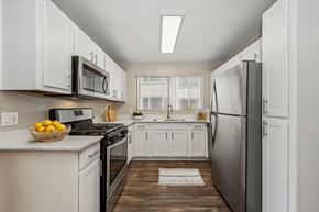Mesa apartment for rent - a white kitchen with stainless steel appliances and white cabinets