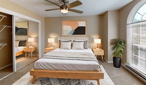 Beaverton apartment for rent - a bedroom with a large bed and a ceiling fan