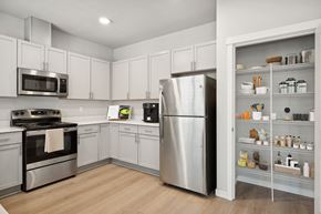 Tacoma apartment for rent - a kitchen with white cabinets and stainless steel appliances