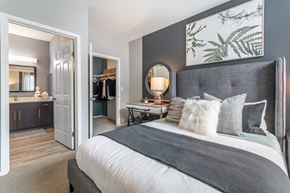 Beaverton apartment for rent - a bedroom with a large bed and a door to a bathroom