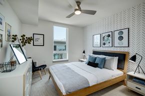 Seattle apartment for rent - a bedroom with a large bed and a ceiling fan
