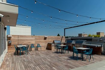 Rooftop deck featuring barbecue pavilion, outdoor fireplace and lounge seating