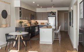 Seattle apartment for rent - a view of a kitchen and a dining room with a table and chairs