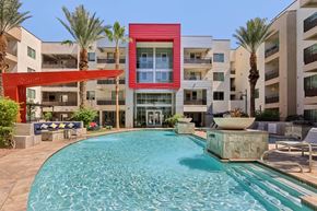 Phoenix apartment for rent - A red building with a pool in front of it.