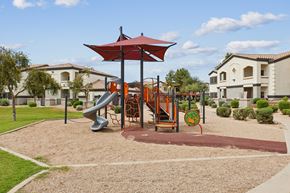 Chandler apartment for rent - A playground with a red umbrella and a slide.