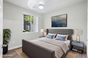 Tracy apartment for rent - A bedroom with a large bed and a painting on the wall.