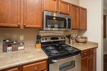 Daphne apartment for rent - A kitchen with a stove, oven, microwave and cabinets.