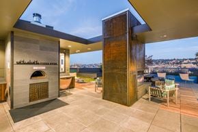 Seattle apartment for rent - A modern outdoor kitchen with a pizza oven and a tall column.